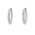 Pair of 14K white gold diamond hoop earrings on a white background