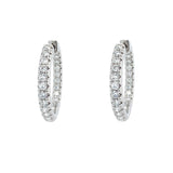Pair of 14K white gold diamond hoop earrings on a white background