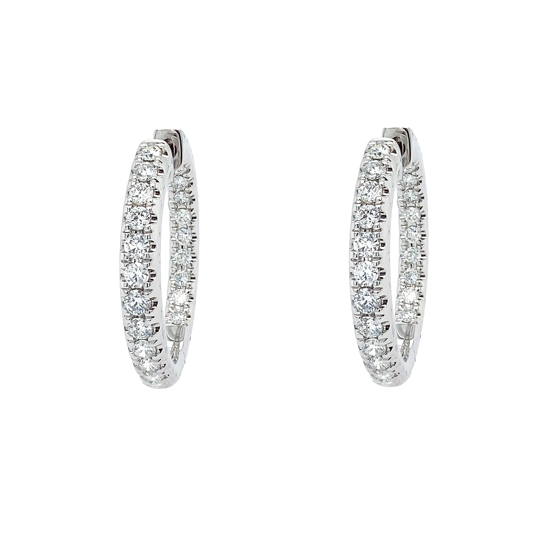 Pair of 14K white gold diamond hoop earrings on a white background