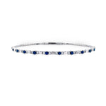 14K white gold bracelet with blue sapphires and diamonds on a white background