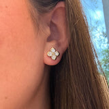 woman wearing 14K gold clover diamond earrings