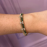 Woman wearing gold bracelets offered by Laura Pearce