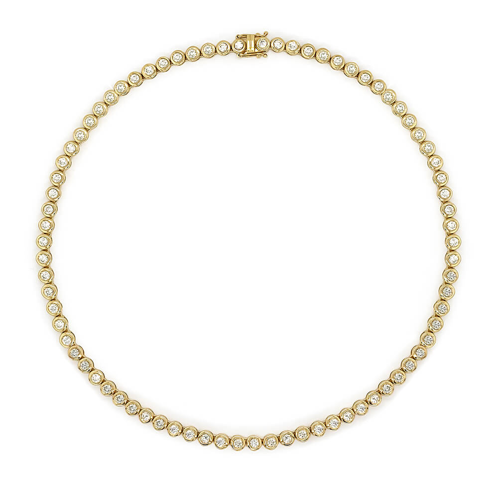 A 14K yellow gold tennis necklace featuring a continuous row of bezel-set clear diamonds, arranged in a circular shape on a solid white background.