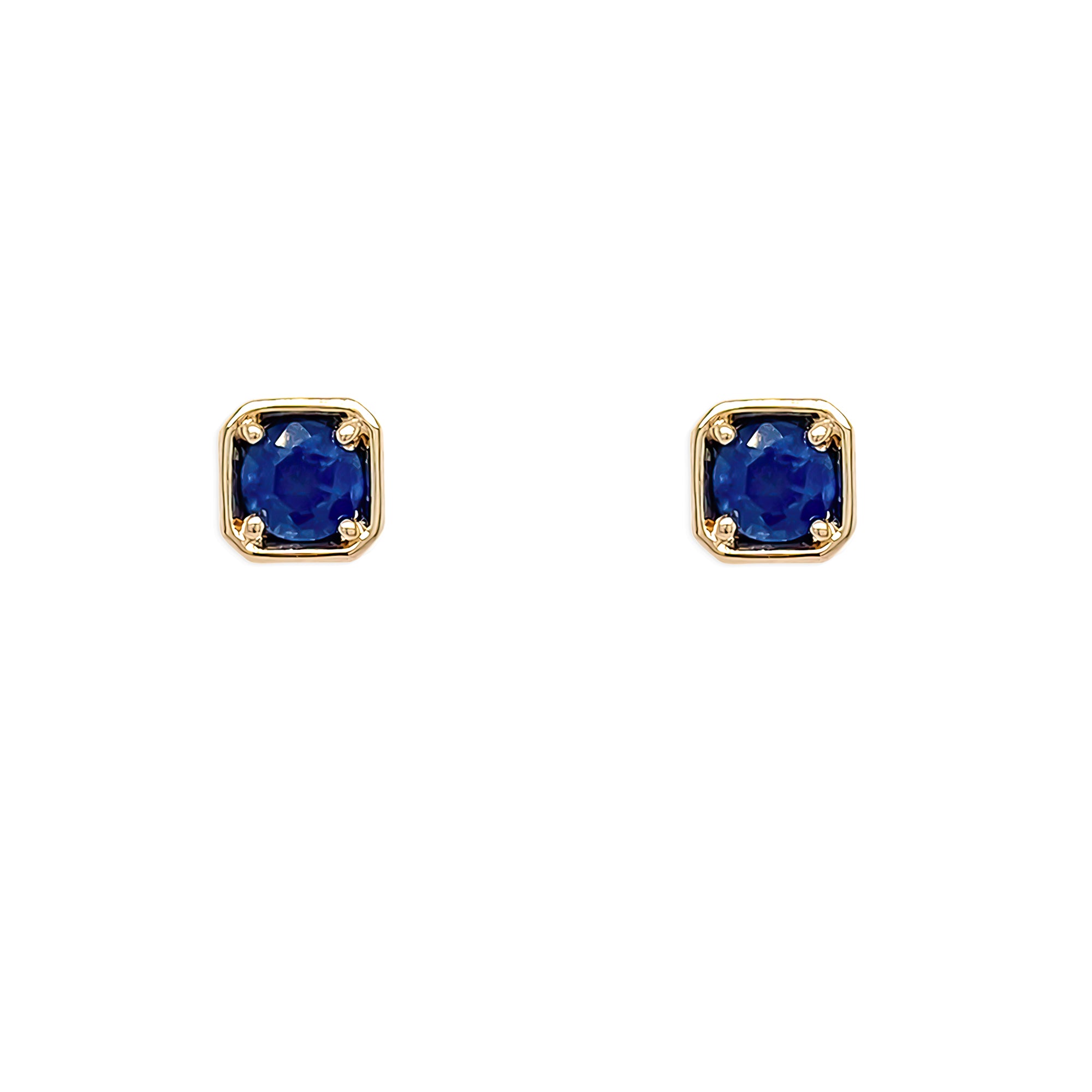 Pair of gold earrings with sapphire gemstones on a white background