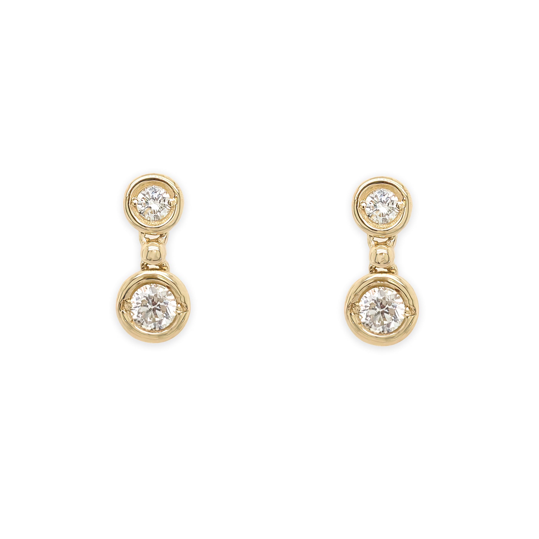 A pair of 14k yellow gold diamond bezel drop earrings.