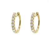 Gold hoop earrings with diamonds on a white background