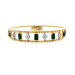 Gold bracelet with emeralds and diamonds on a white background
