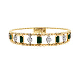 Gold bracelet with emeralds and diamonds on a white background