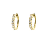 Gold hoop earrings with diamonds on a white background