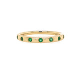 14K Gold ring with emerald stones on a white background