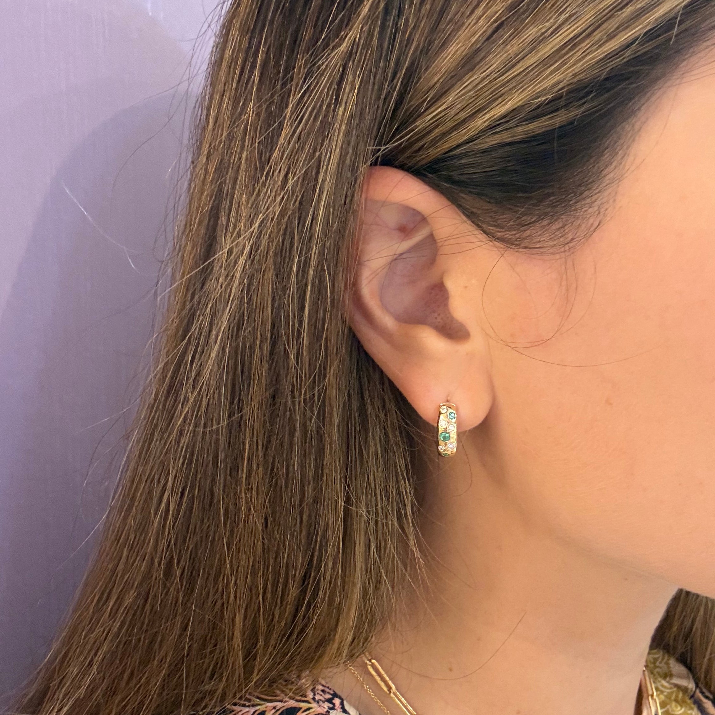 14k-Yellow-Gold-Emerald-and-Diamond-Scatter-Huggies on ear