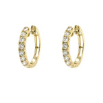 Gold hoop earrings with diamonds on a white background