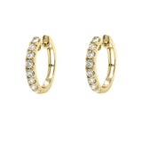 Gold hoop earrings with diamonds on a white background
