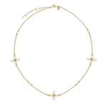 14K Gold necklace with pearl pendants on a white background
