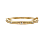 14K Gold bangle with embedded diamonds on a white background