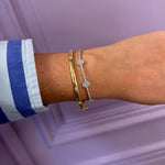 14K white gold flex diamond bracelet worn on a woman's wrist.