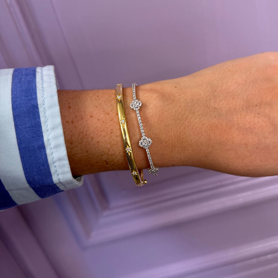 14K white gold flex diamond bracelet worn on a woman's wrist.