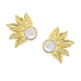 Gold leaf-shaped earrings with central moonstones and accent diamonds on a white background