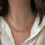 14K Gold Circle Link chain necklace worn by a woman with a white shirt and brown hair.