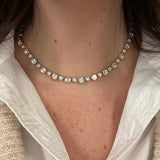 Close-up of a woman wearing a 14K gold necklace with White Topaz stones 