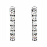 A pair of 14K white gold huggie hoop earrings with diamonds