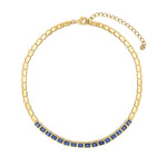 A 14K yellow gold chain necklace with a row of square-cut blue sapphires along the front, displayed on a clean white background.