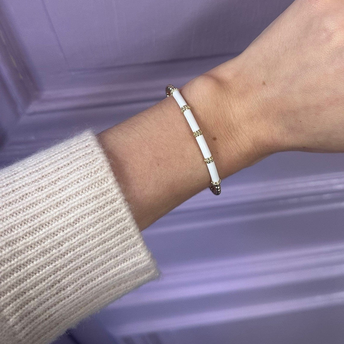 14k yellow gold white enamel a=bangle on wrist