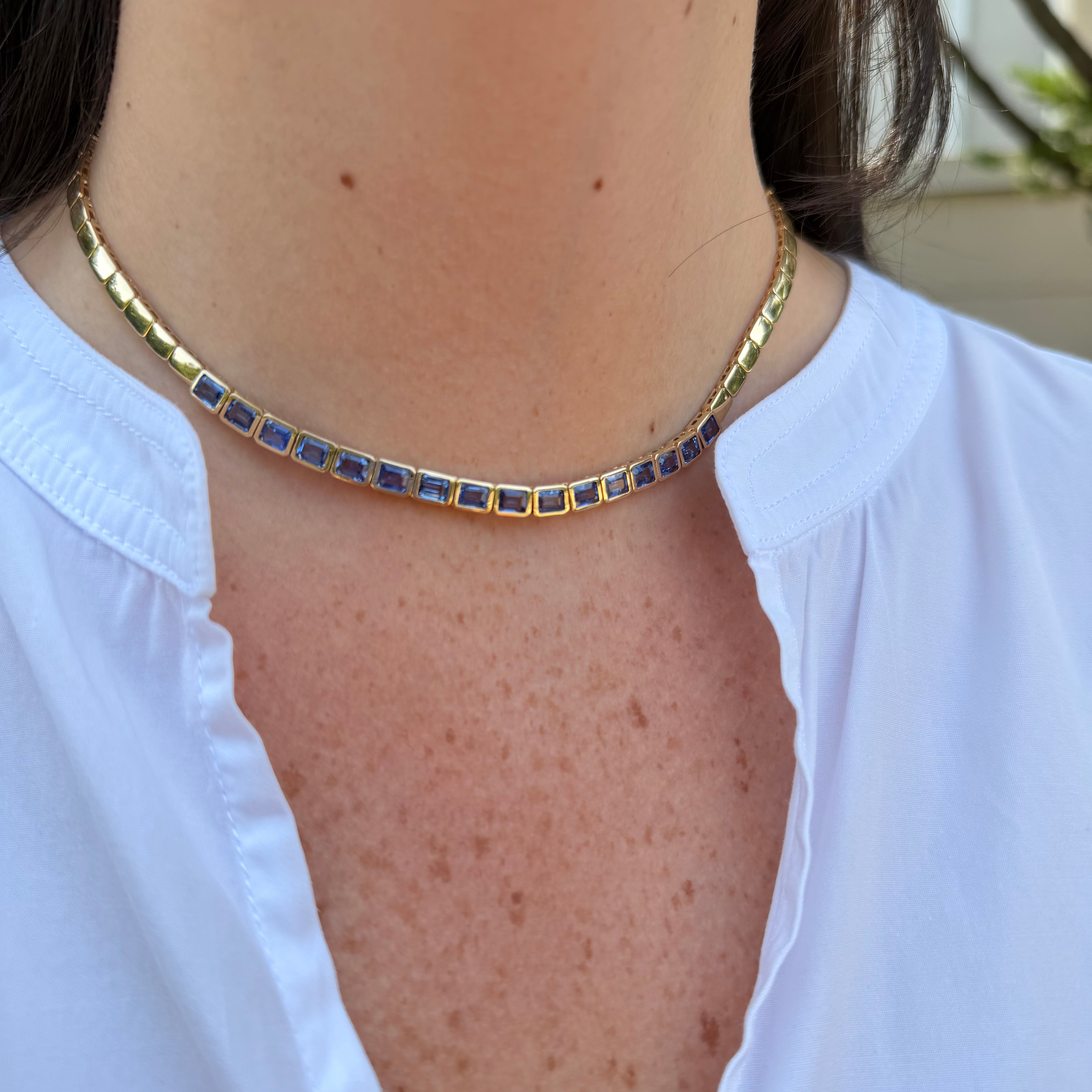 14k yg sapphire necklace on neck