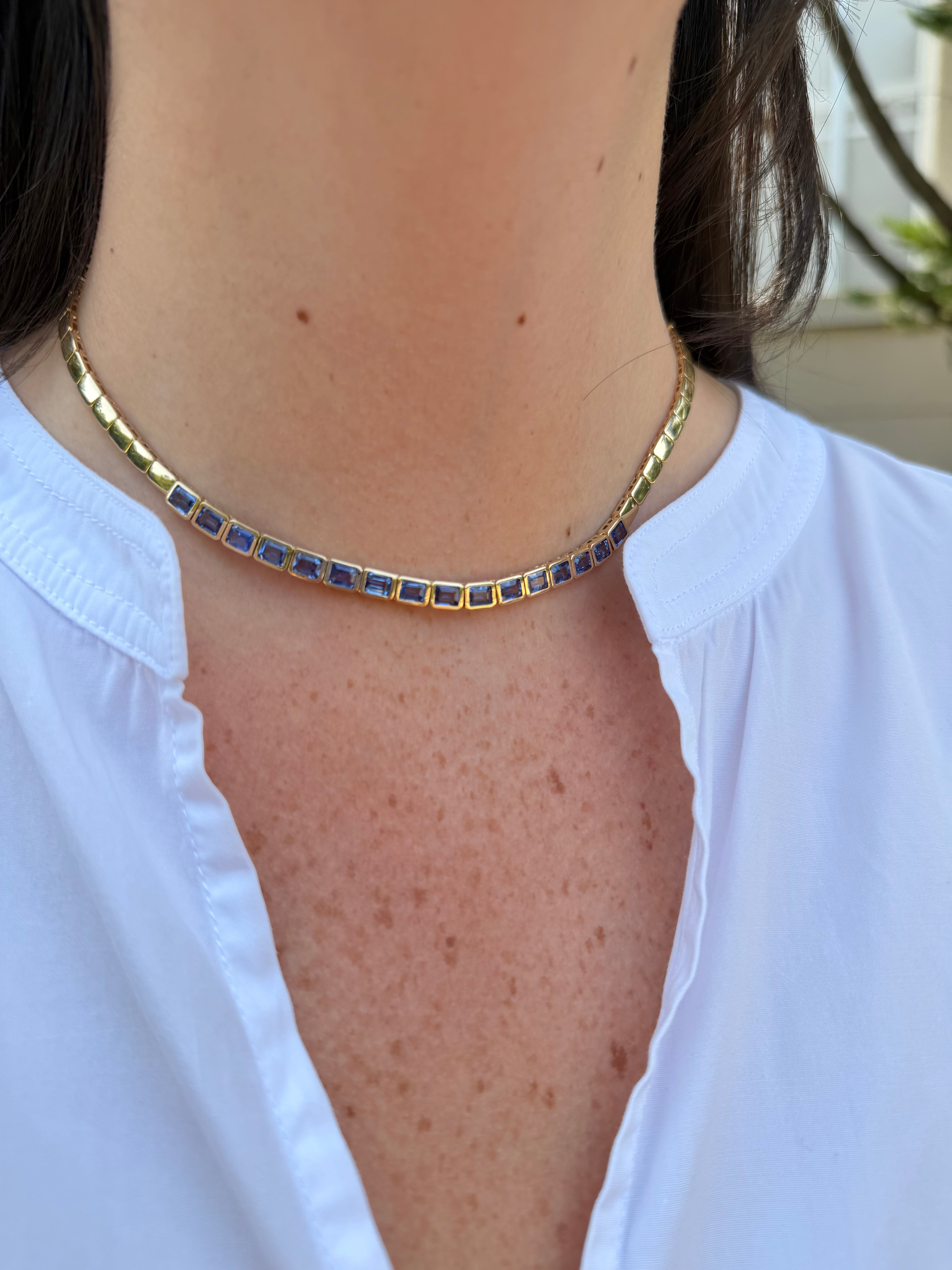 14k yg sapphire necklace on neck