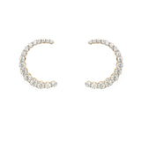 Pair of 14K gold C-shaped earrings with diamonds on a white background