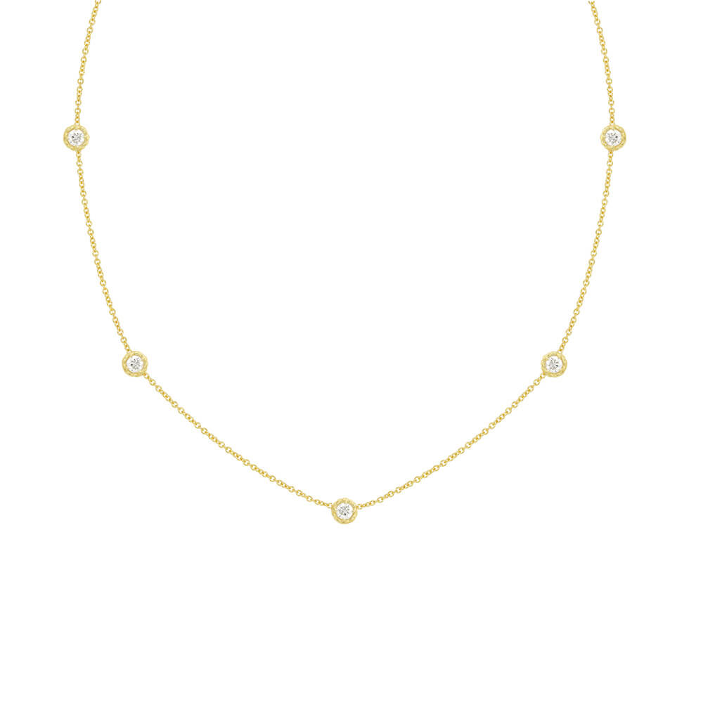 A 18K yellow gold necklace with a series of twist bezel set diamonds by the yard.