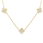 An 18K yellow gold necklace featuring 3 diamond encrusted clover stations.