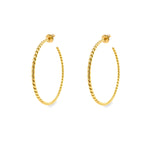 A pair of 18K yellow gold twist hoop earrings on a white background.