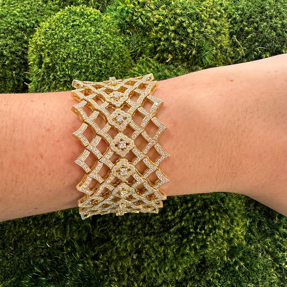 18K Gold lattice-design bracelet with diamonds on a wrist 