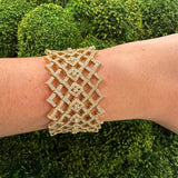 18K Gold lattice-design bracelet with diamonds on a wrist 