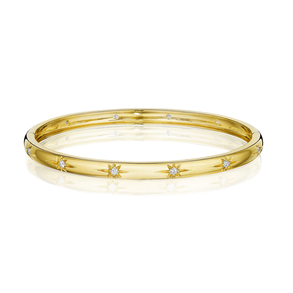 An 18K yellow gold diamond starburst bangle bracelet with multiple inset diamonds
