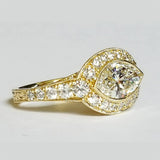 A custom designed 18kt yellow gold marquise diamond ring with a large central diamond and smaller surrounding diamonds set in a 18K gold band.