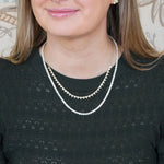 Woman wearing a Diamond Tennis necklace.