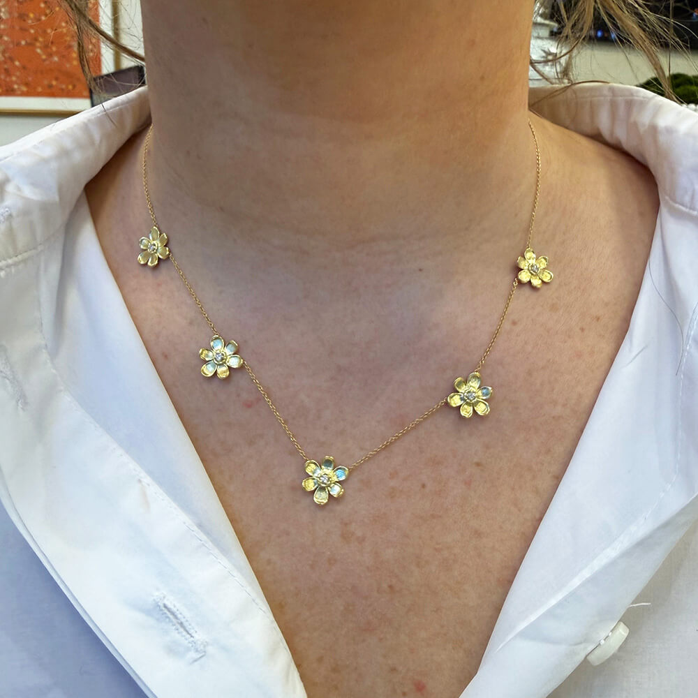18K gold pave diamond 5 station flower necklace on model