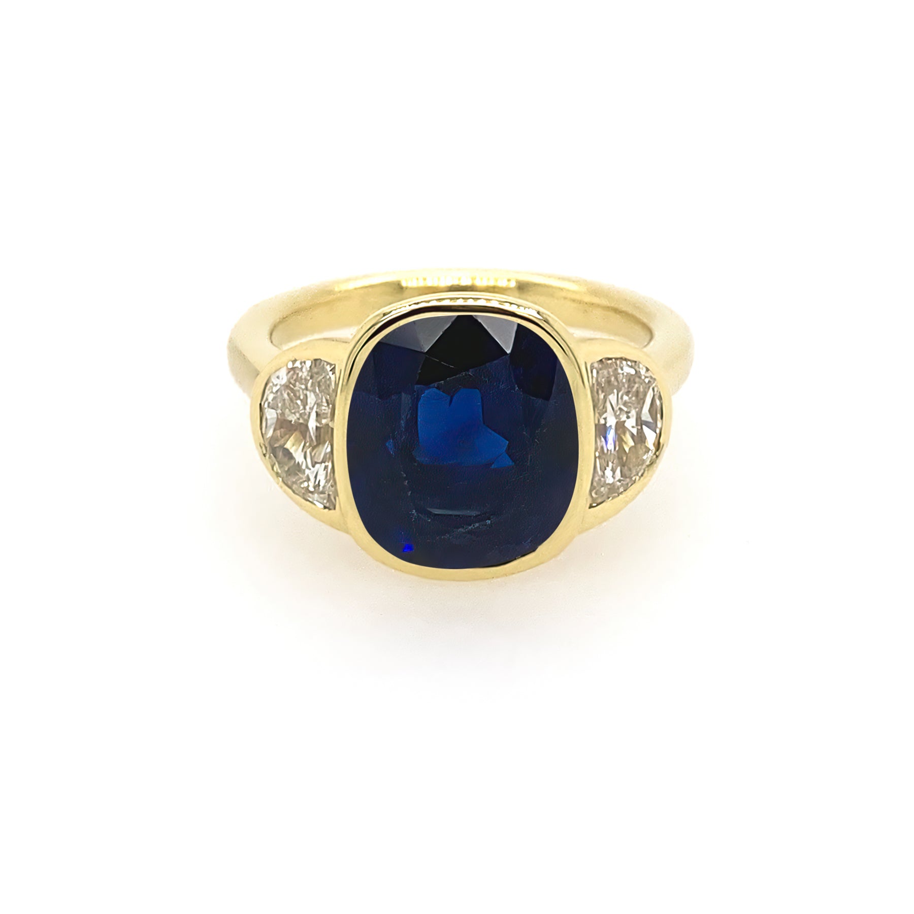 An 18kt yellow gold ring with a bezel set sapphire and diamonds.