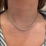 18K Yellow Gold Diamond Tennis Necklace worn by a woman with a striped garment