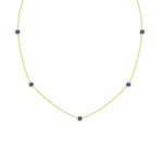 18K Gold necklace with blue sapphire gemstones on a white background