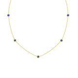 18K Gold necklace with blue sapphire gemstones on a white background
