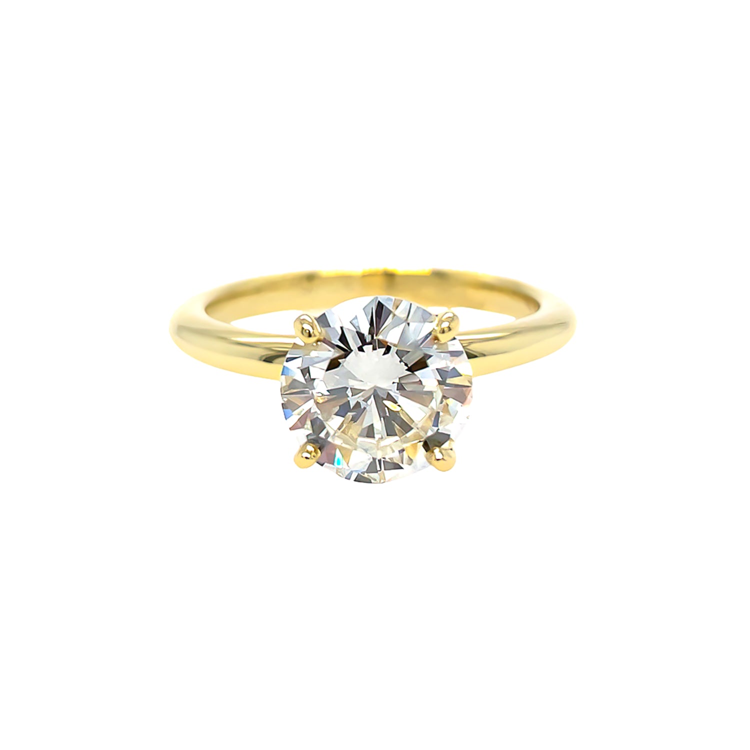 An 18K yellow gold solitaire round diamond ring with a visible gold band and a single central diamond.