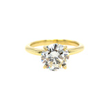 An 18K yellow gold solitaire round diamond ring with a visible gold band and a single central diamond.