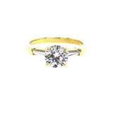 An 18kt yellow gold ring with a single diamond stone set in a gold band