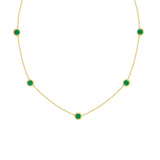 18K Gold necklace with green emerald gemstones on a white background