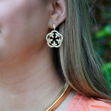 Close-up of a woman wearing an 18K gold scalloped clover earring with diamonds designed by Laura Pearce