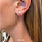 Close-up of an ear wearing a diamond earring with '1.80 cttw' label.