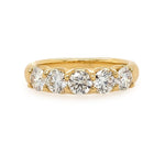 18K Gold ring with five diamonds on a white background